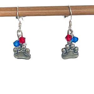 KU Just Cute Dangle Silver Paws Earrings With Red/blue accent crystals.